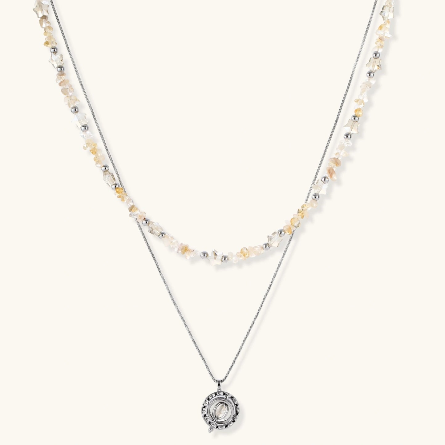 Complete jewelry set featuring citrine stone chips, silver beads, and cosmic circle pendants on cream background.