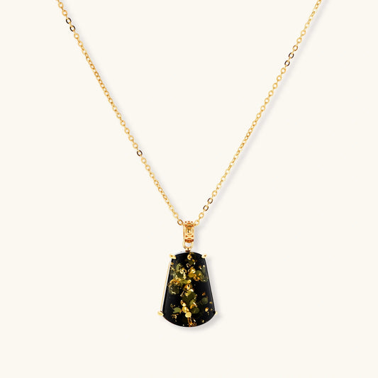 18k gold-plated necklace and earrings with green amber pendants featuring golden inclusions on cream background